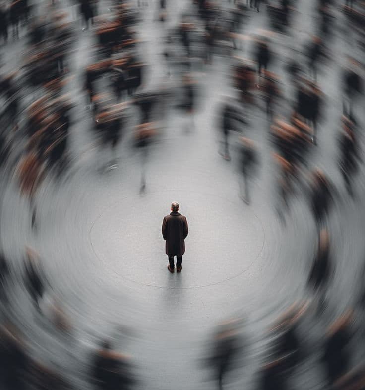 man standing in chaotic environment at a train station
